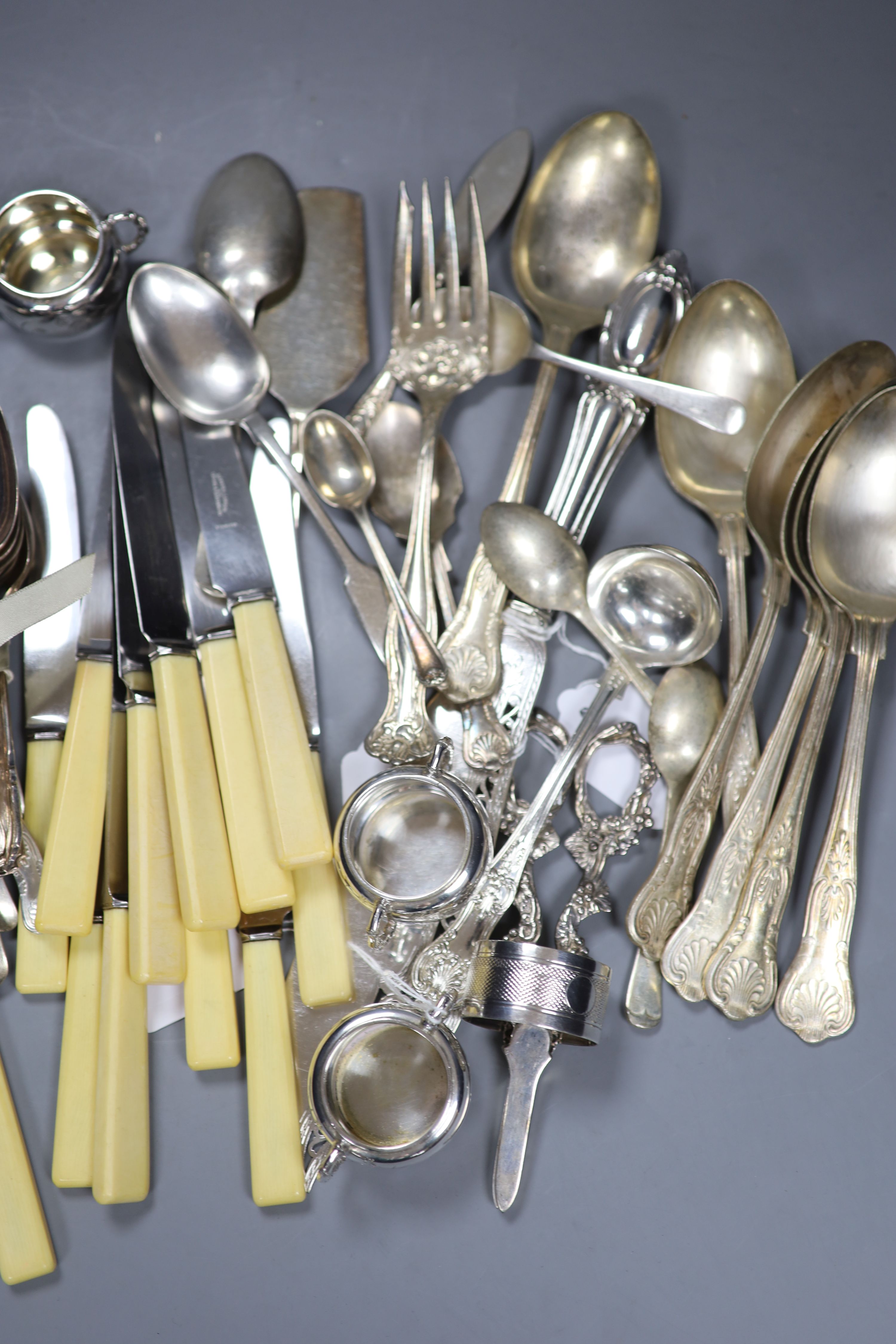 A pair of plated grape scissors, a set of three engraved plated salts, a napkin ring and sundry plated flatware